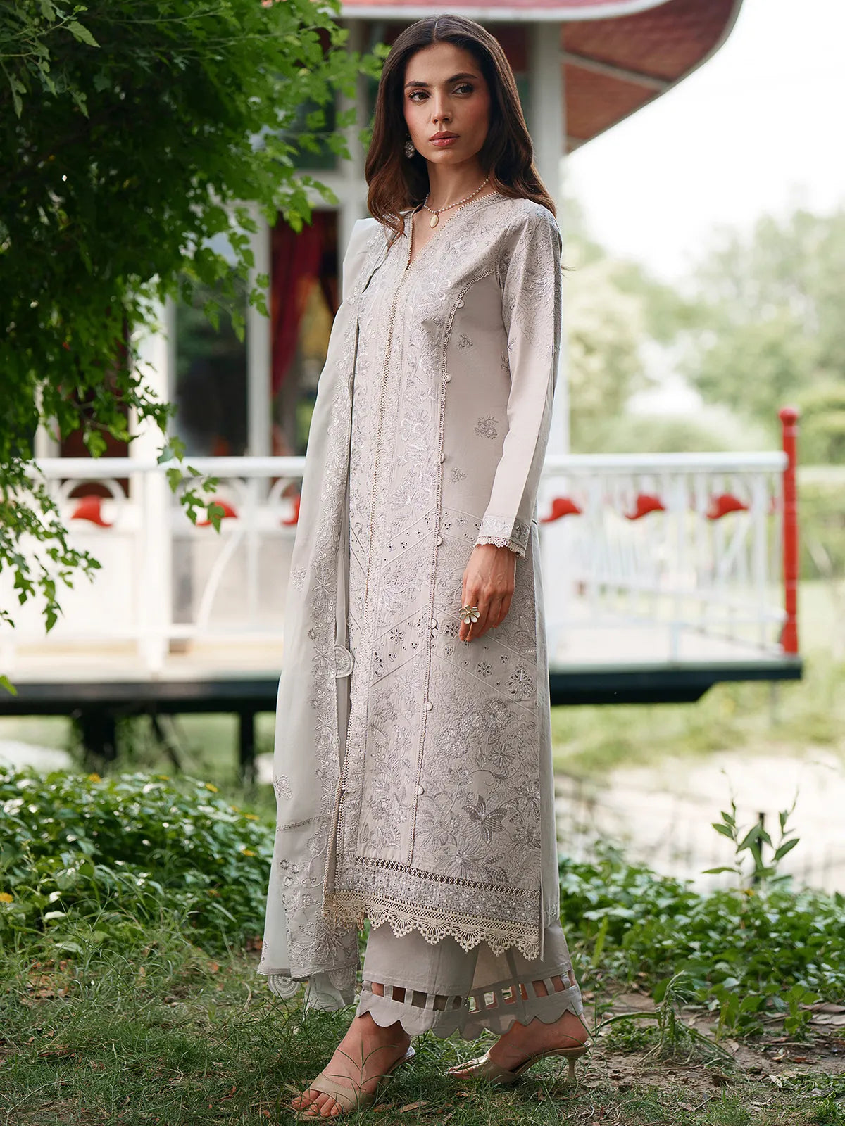 Close-up front and sleeve detail of light grey lawn stitched 3-piece suit featuring delicate tonal embroidery and lace trim from Baad-e-Saba by INEJ.