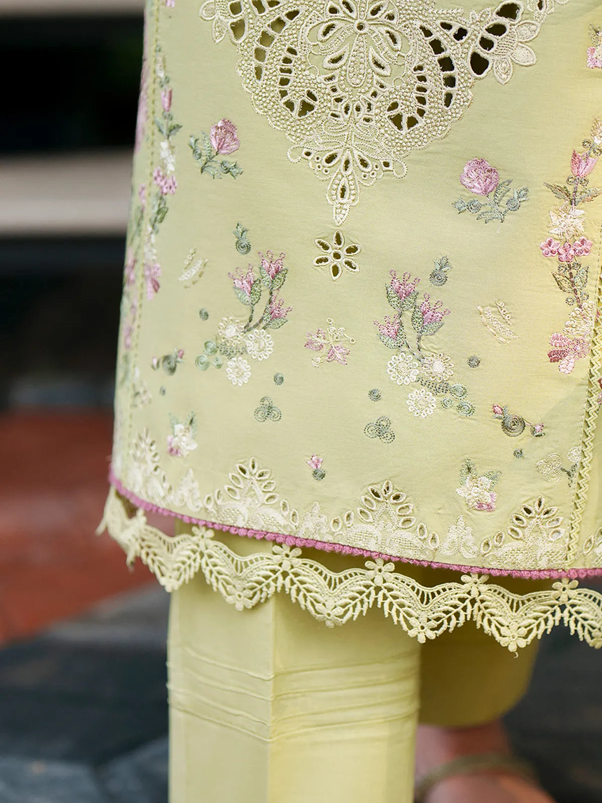 Close-up hem and trouser detail of olive green lawn stitched 3-piece suit featuring intricate cutwork border, floral embroidery, and lace trim from Baad-e-Saba by INEJ.