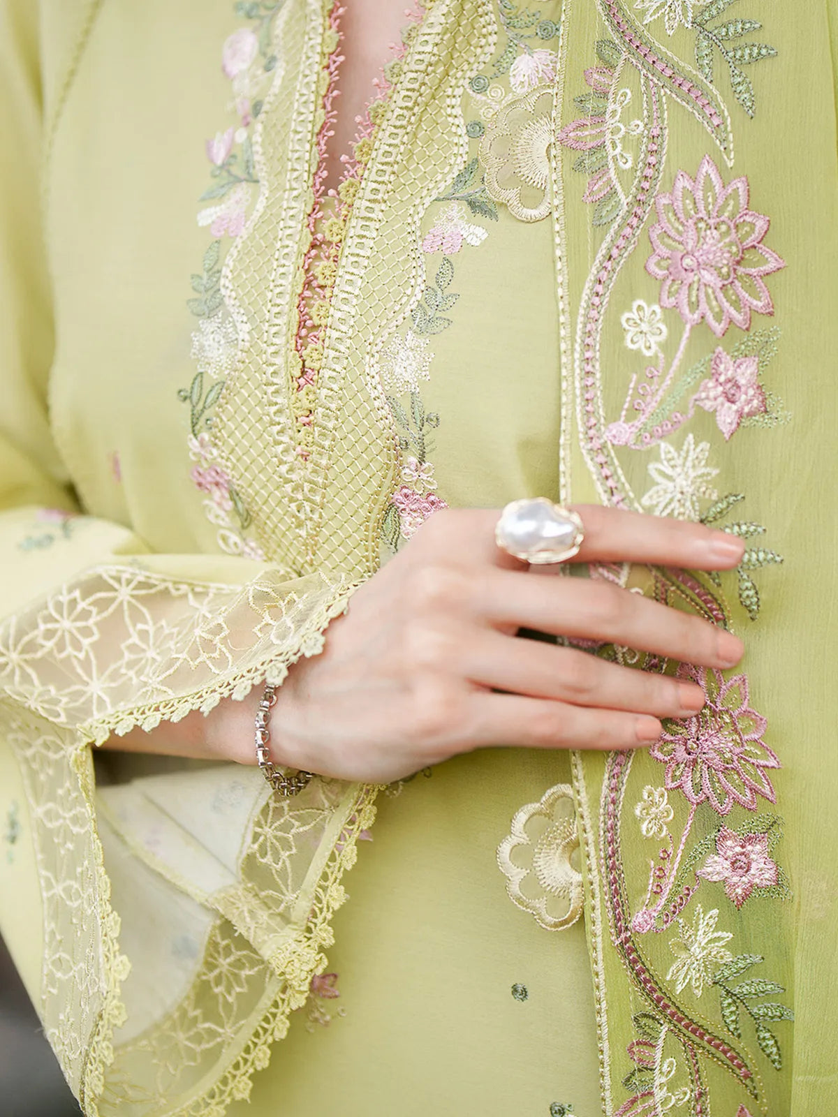 Close-up neckline and dupatta detail of olive green lawn stitched 3-piece suit featuring pink floral embroidery and lace trim from Baad-e-Saba by INEJ.