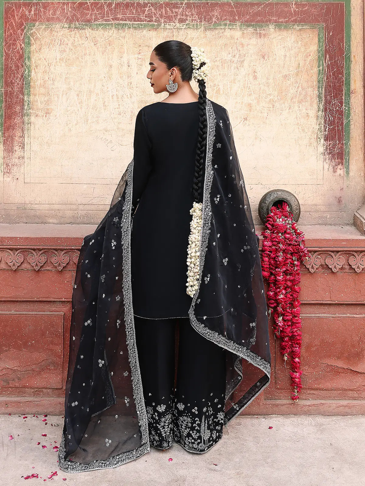 Back full-length view of black stitched 3-piece luxury silk suit with draped organza dupatta from Khat by INEJ.