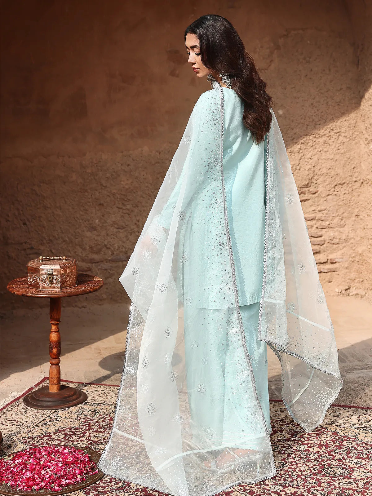 Back full-length view of ice blue stitched 3-piece luxury silk suit with draped organza dupatta from Khat by INEJ.