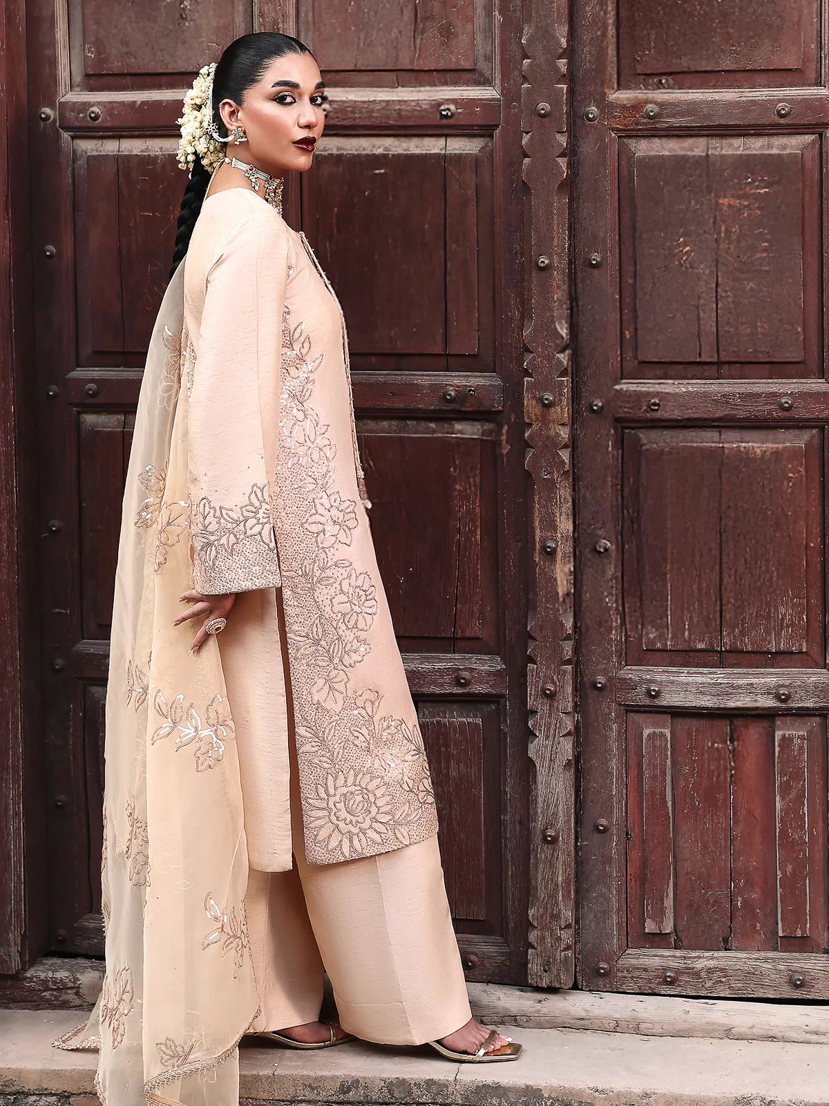 Side full-length view of peach embroidered stitched 3-piece luxury silk suit from Khat by INEJ.