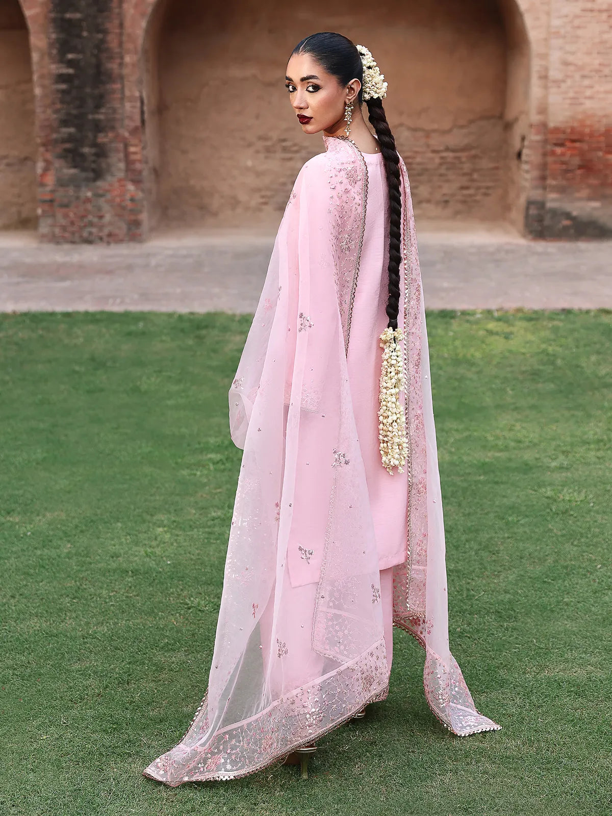 Back full-length view of pink stitched 3-piece luxury silk suit with draped dupatta from Khat by INEJ.