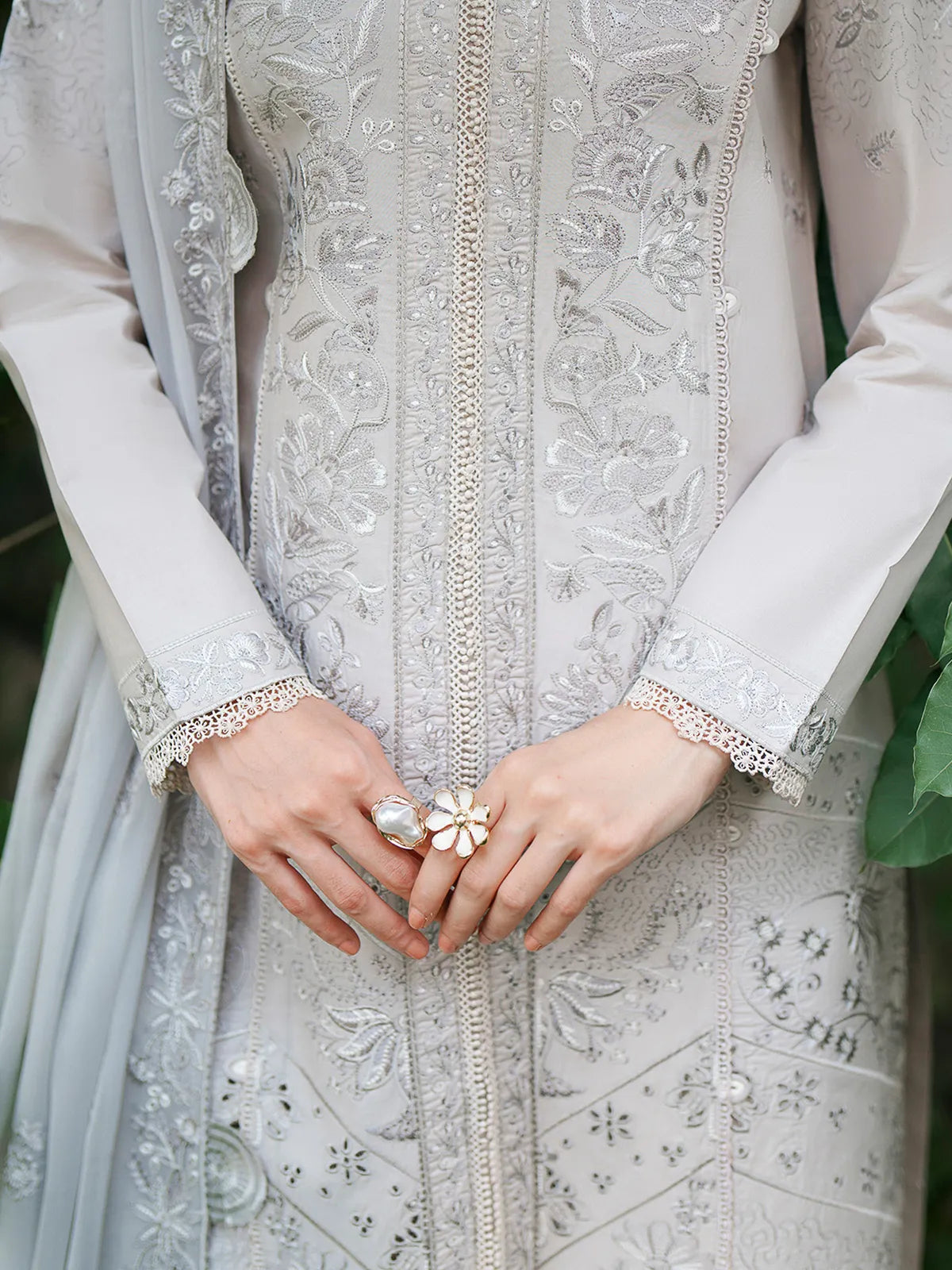 Close-up front and sleeve detail of light grey lawn stitched 3-piece suit featuring delicate tonal embroidery and lace trim from Baad-e-Saba by INEJ.