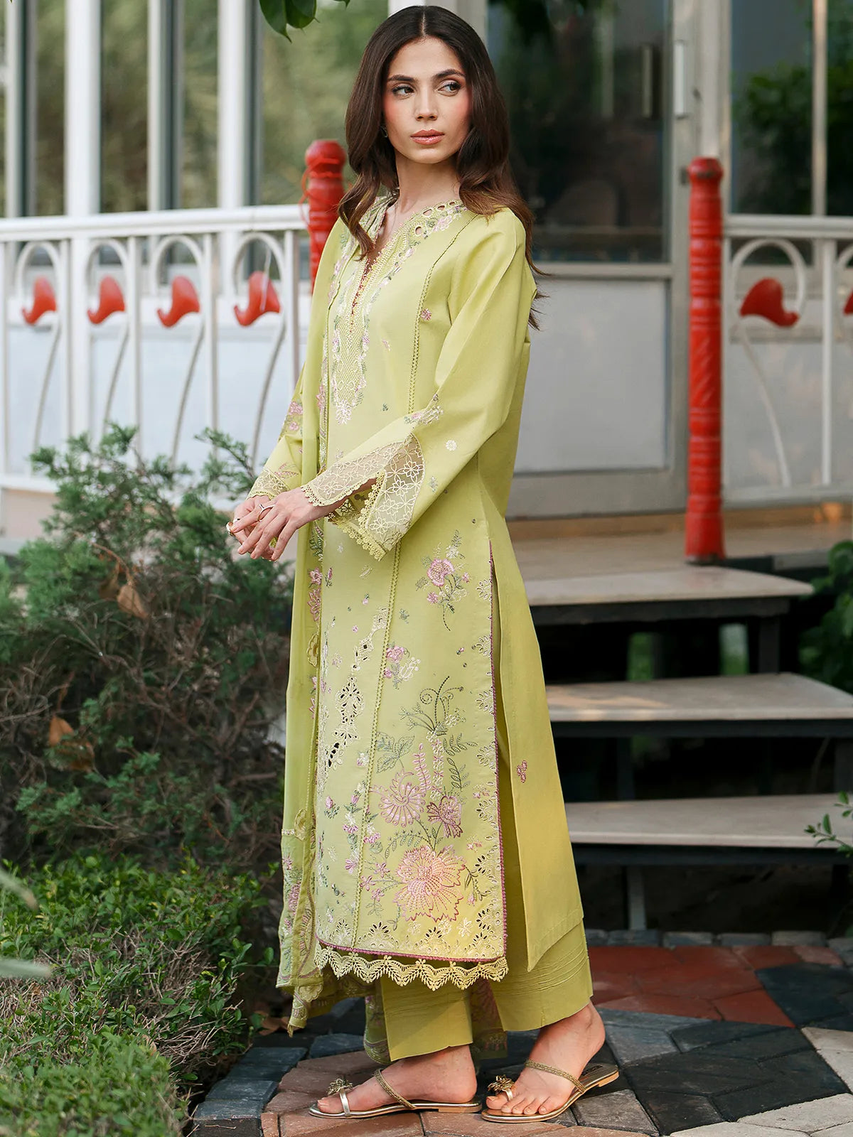 Side profile view of olive green lawn stitched 3-piece suit featuring pink floral embroidery and cutwork details from Baad-e-Saba by INEJ.
