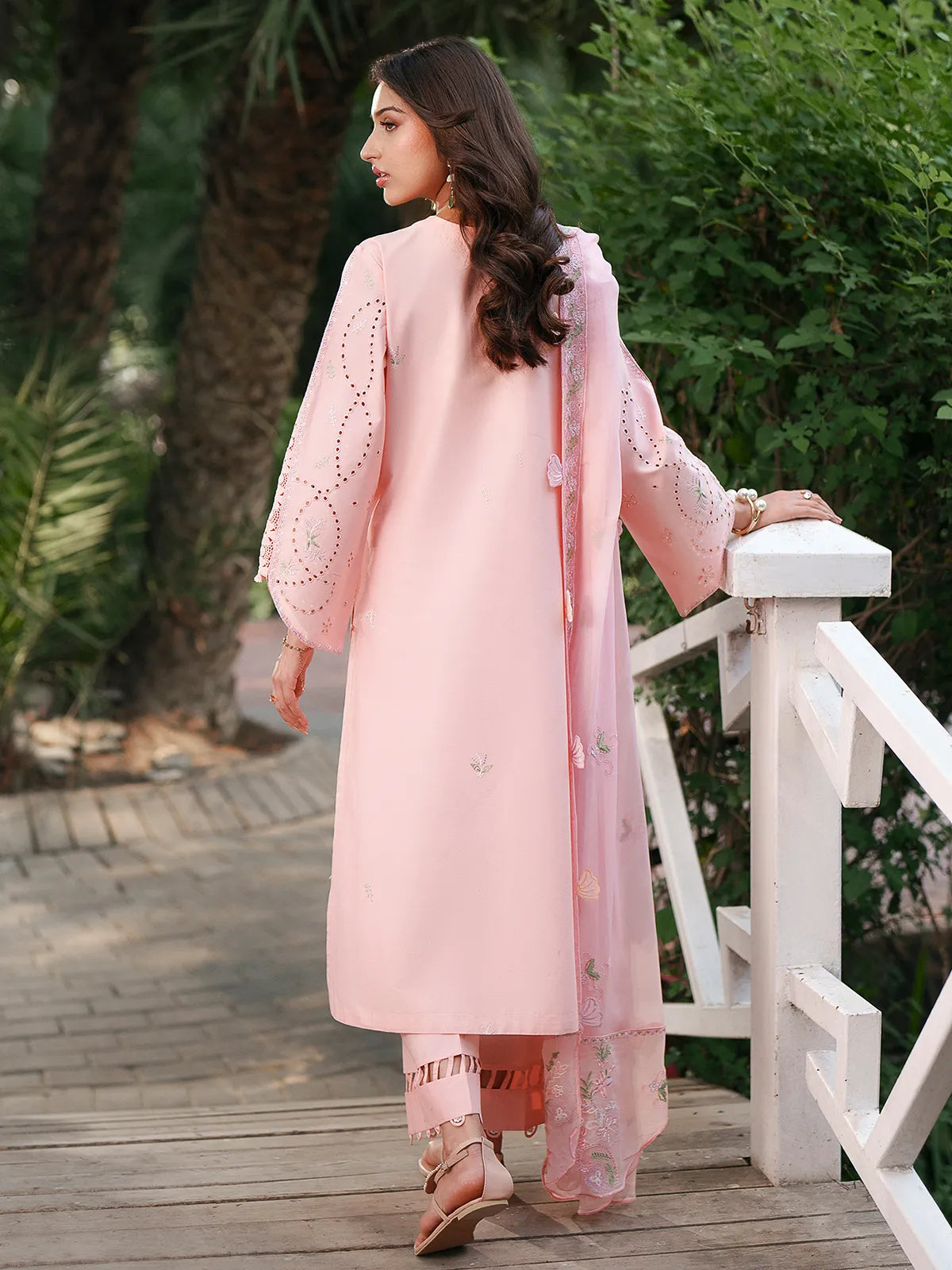 Back full-length view of pink lawn stitched 3-piece suit featuring eyelet sleeve details, embroidered dupatta, and cutwork trouser hem from Baad-e-Saba by INEJ.