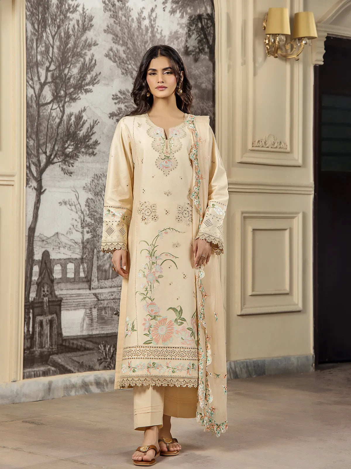 Full front view of a model wearing a beige 3-piece embroidered lawn suit with matching scalloped dupatta and tailored trousers by INEJ.