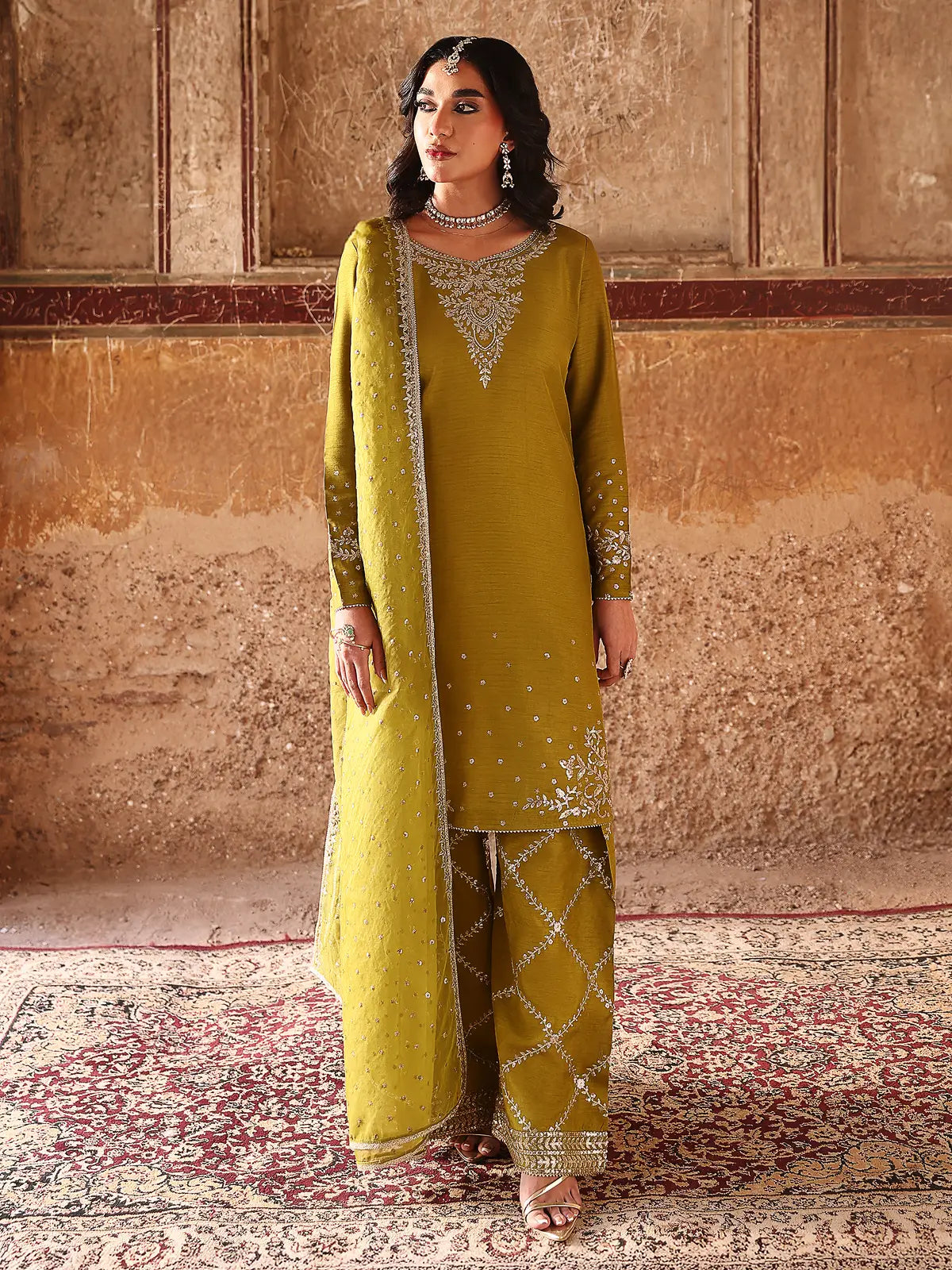 Front full-length view of olive green embroidered stitched 3-piece luxury silk suit from Khat by INEJ.