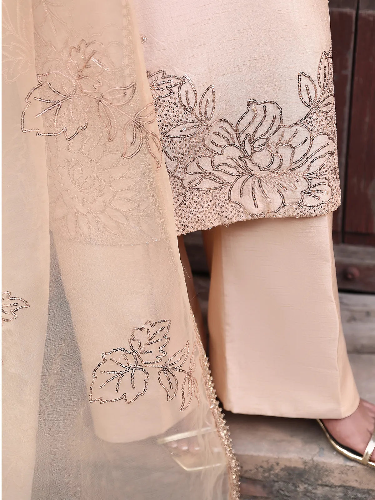 Close-up view of floral embroidered shirt daman and organza dupatta border on peach silk suit from Khat by INEJ.