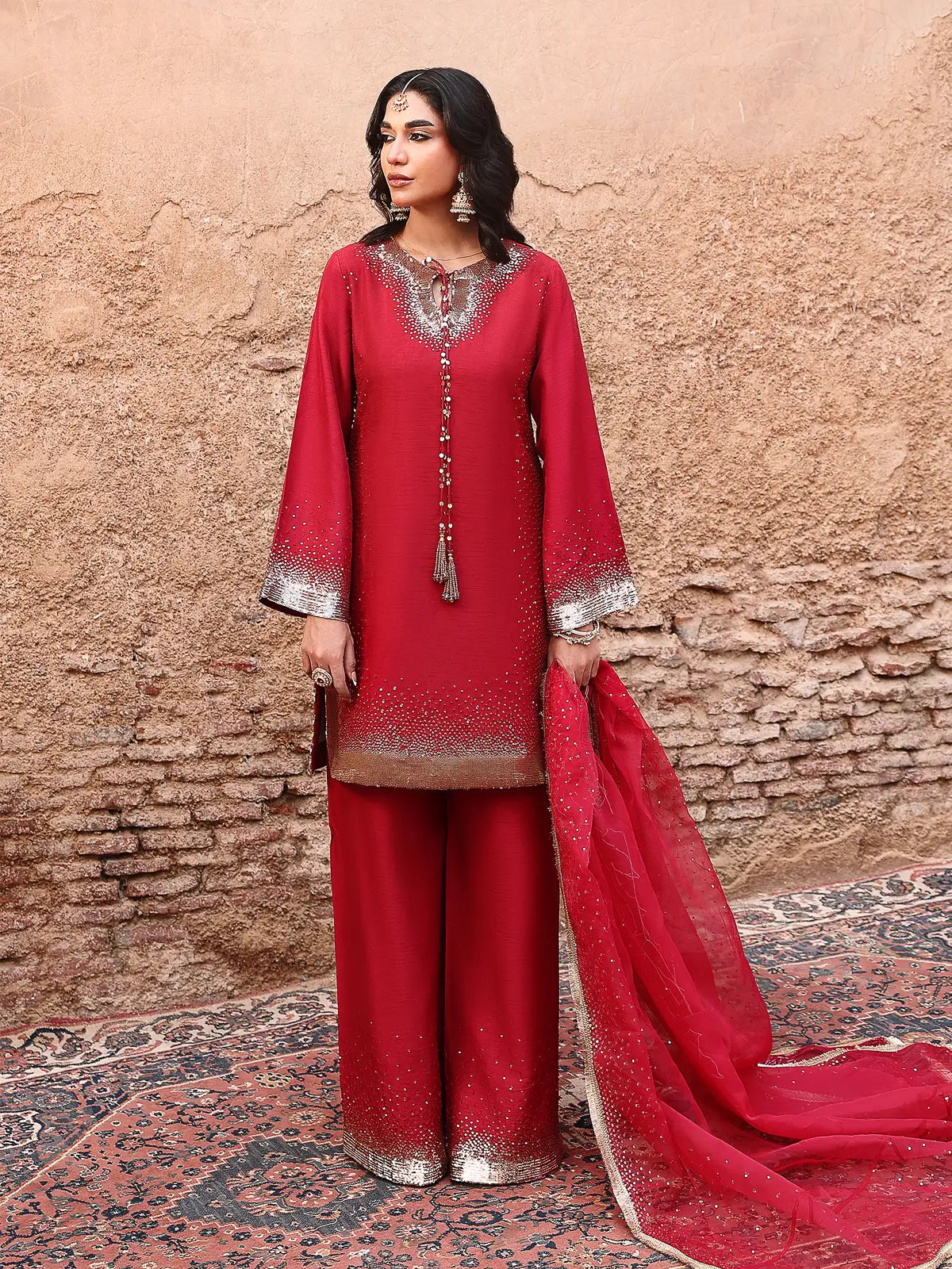 Front full-length view of red embroidered stitched 3-piece luxury silk suit from Khat by INEJ.