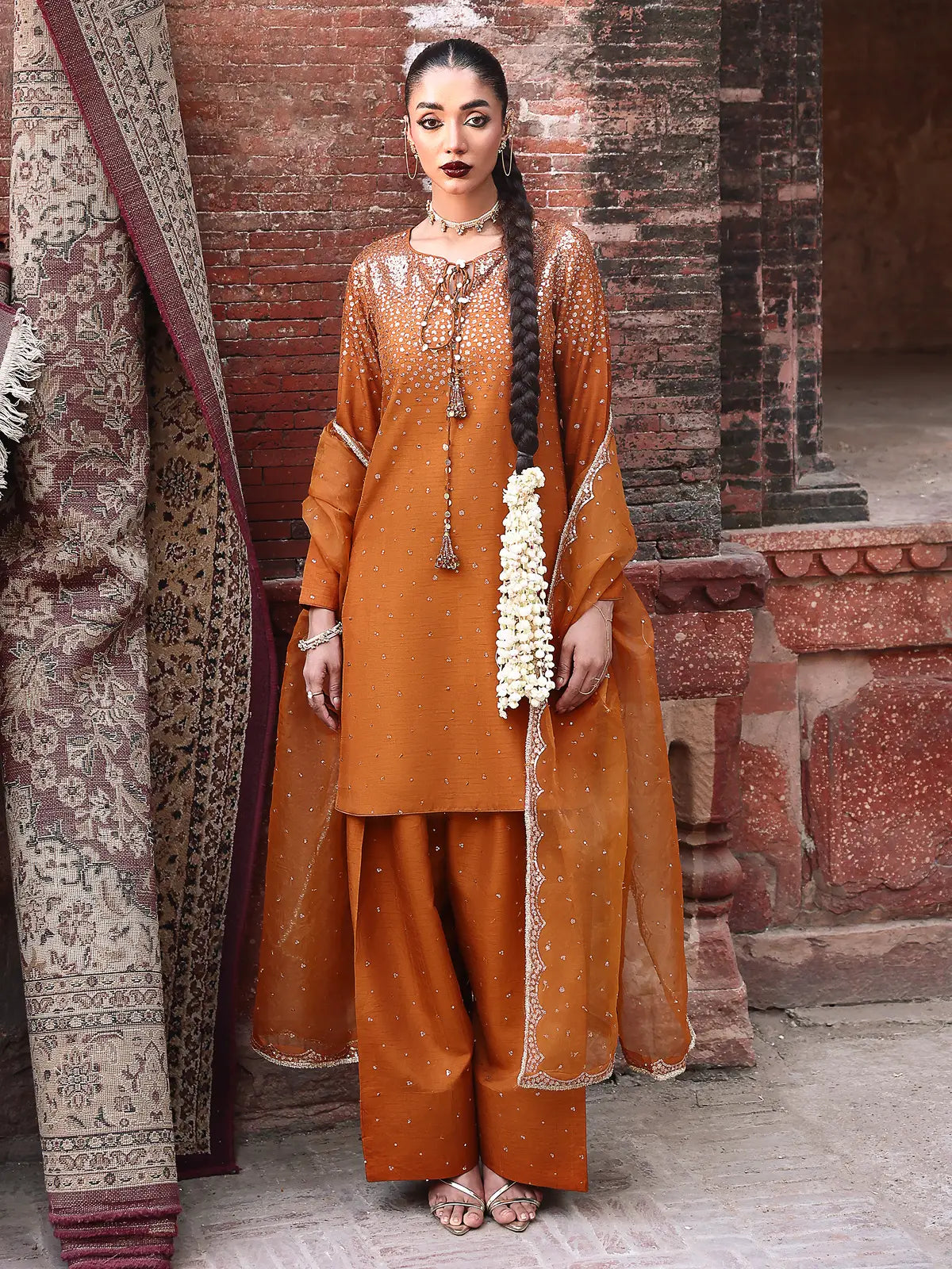 Front full-length view of rust embroidered stitched 3-piece luxury silk suit from Khat by INEJ.