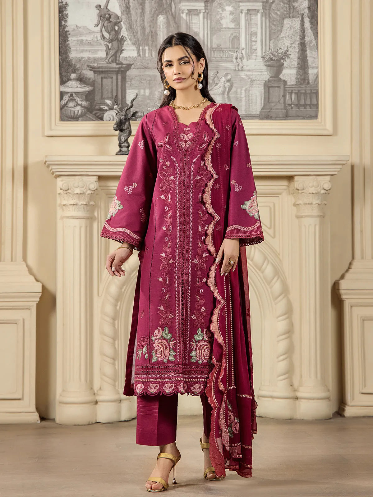 Full front view of a model wearing a deep maroon 3-piece embroidered lawn suit with matching scalloped dupatta and tailored trousers by INEJ.