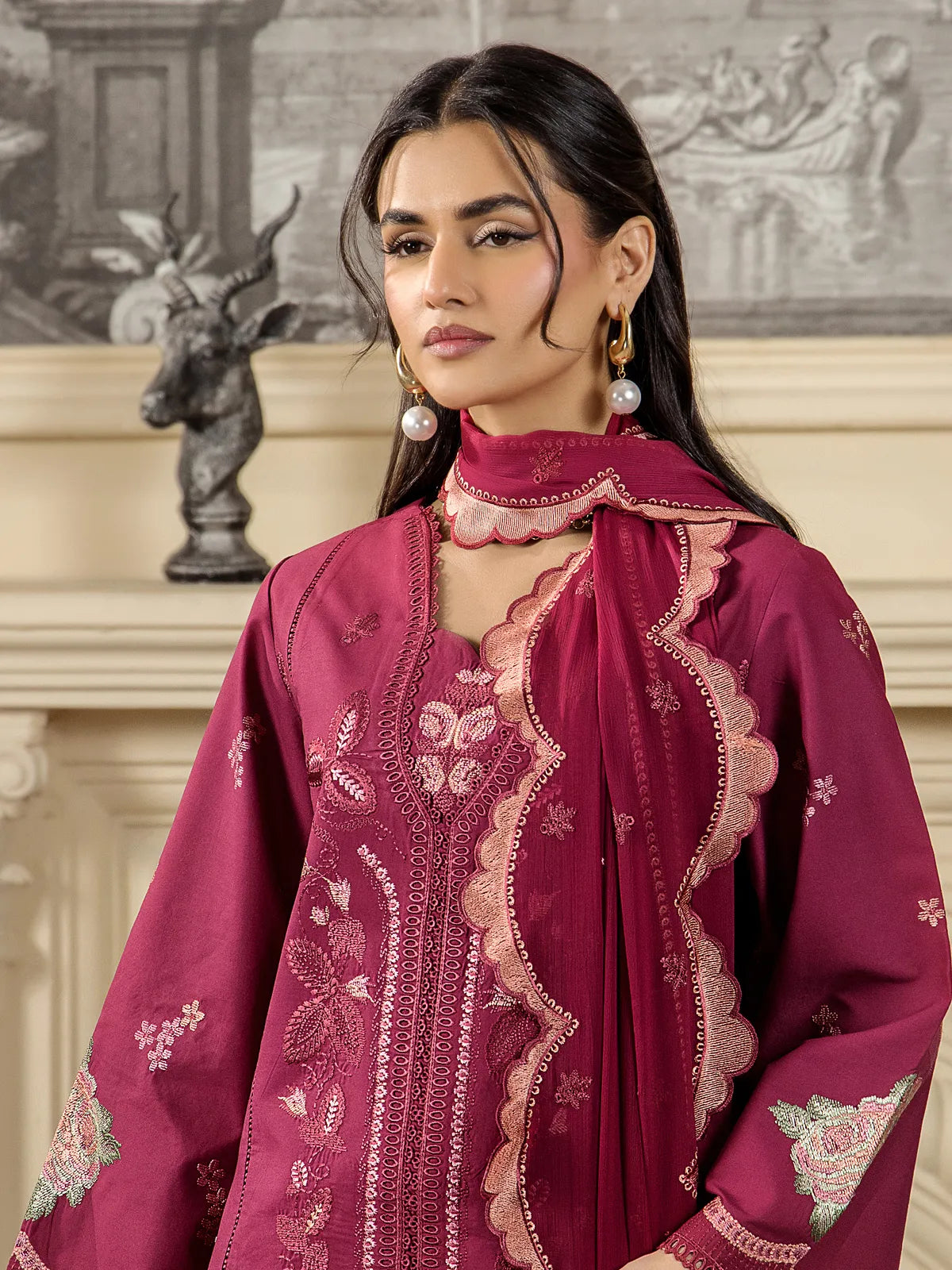 Close-up view of intricate floral neck embroidery, fine lace detailing, and scalloped embroidered dupatta border on maroon lawn suit by INEJ.