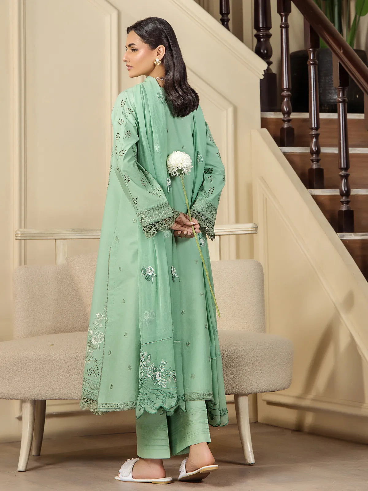 Back view showing the silhouette, scalloped dupatta drape, and tailored finish of the mint green embroidered lawn suit by INEJ.