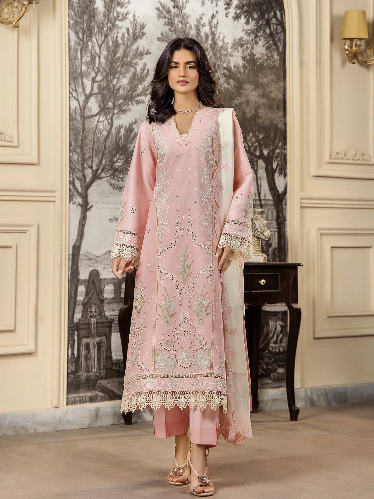 Full front view of a model wearing a soft pink 3-piece embroidered lawn suit with an off-white embroidered dupatta and tailored trousers by INEJ.
