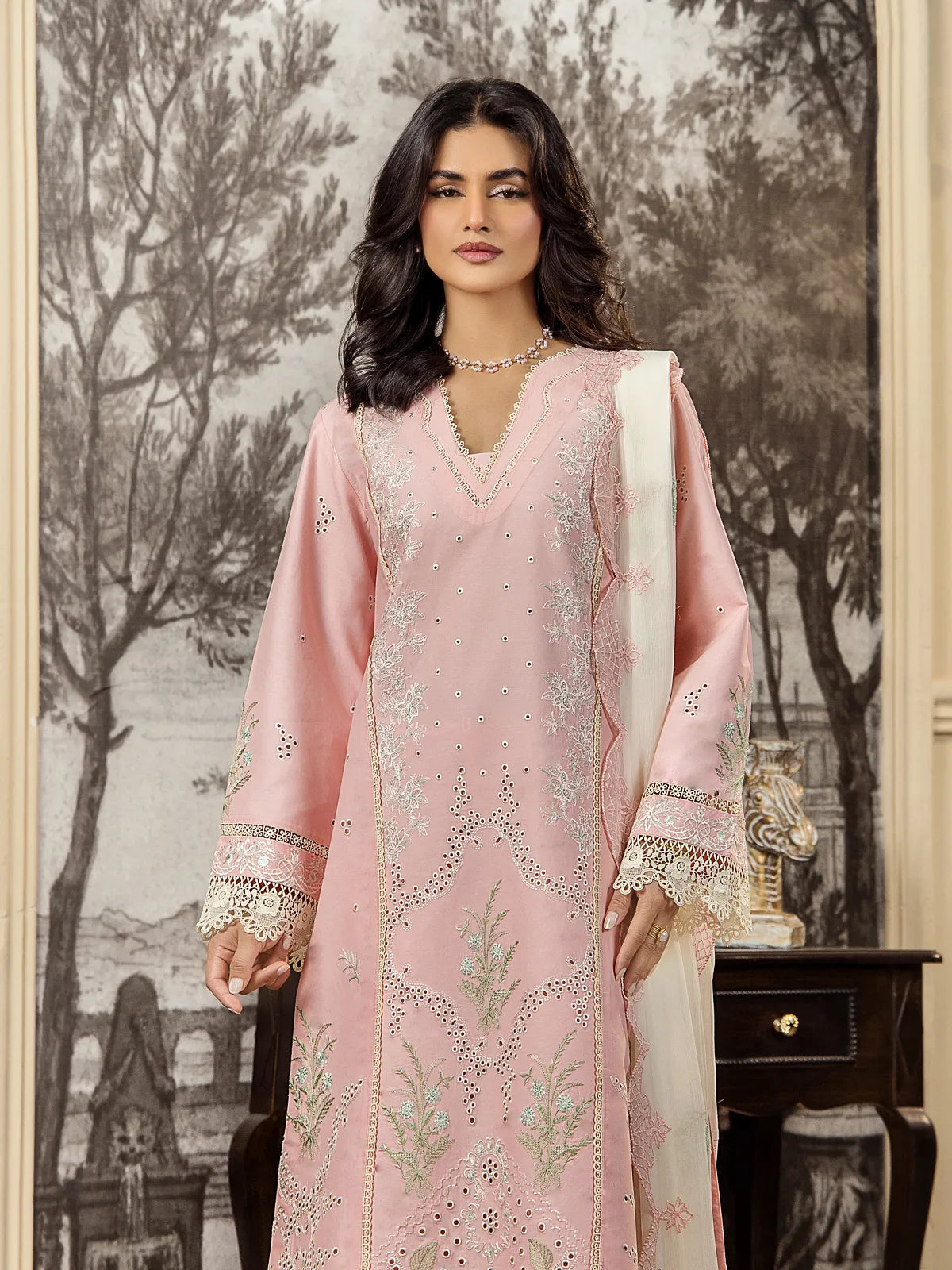 Medium view showing V-neckline embroidery, schiffli cutwork details, and lace sleeve borders on a soft pink lawn shirt by INEJ.