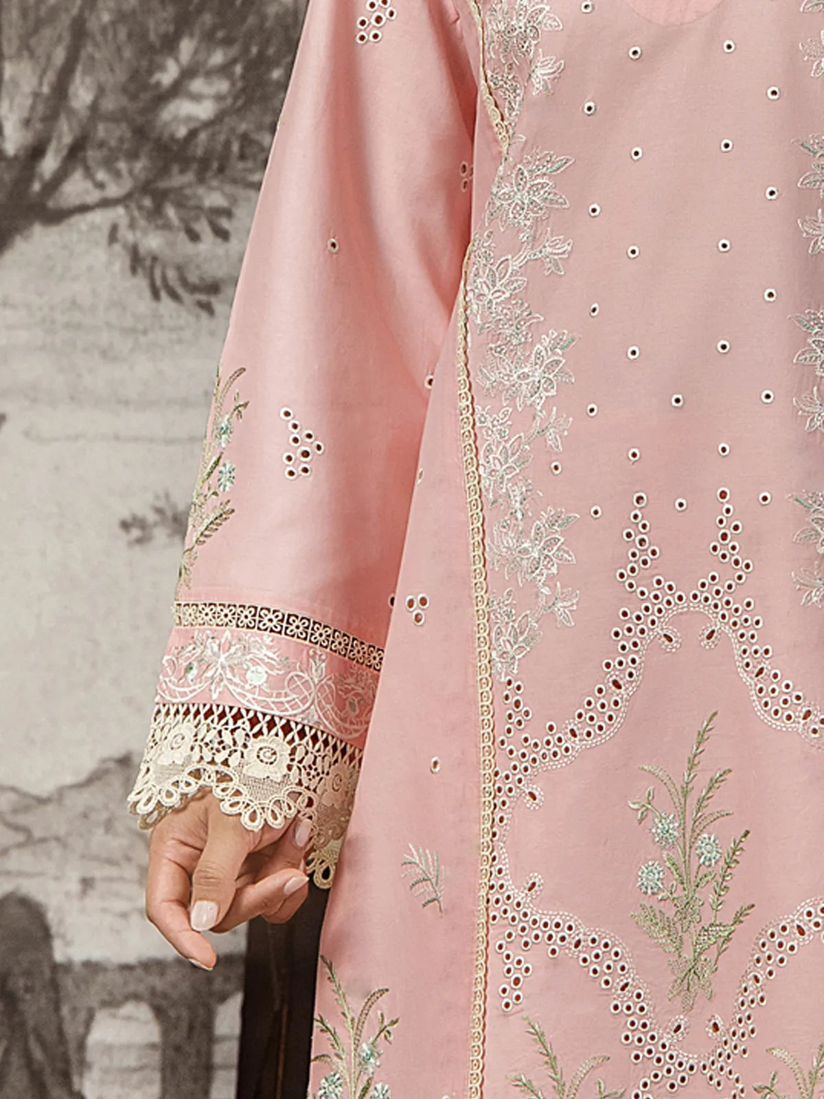 Detailed close-up of schiffli cutwork embroidery, floral threadwork, and scalloped lace cuff edging on soft pink lawn sleeves by INEJ.