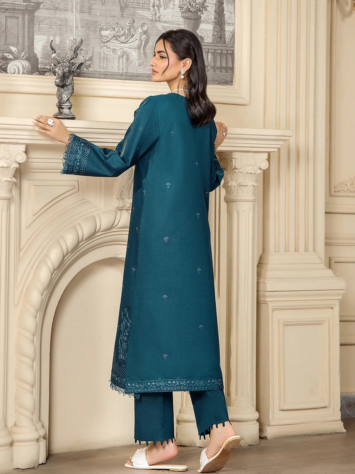 Back view showing the silhouette, tailored fit, and subtle motif detailing of the teal blue embroidered lawn shirt by INEJ.