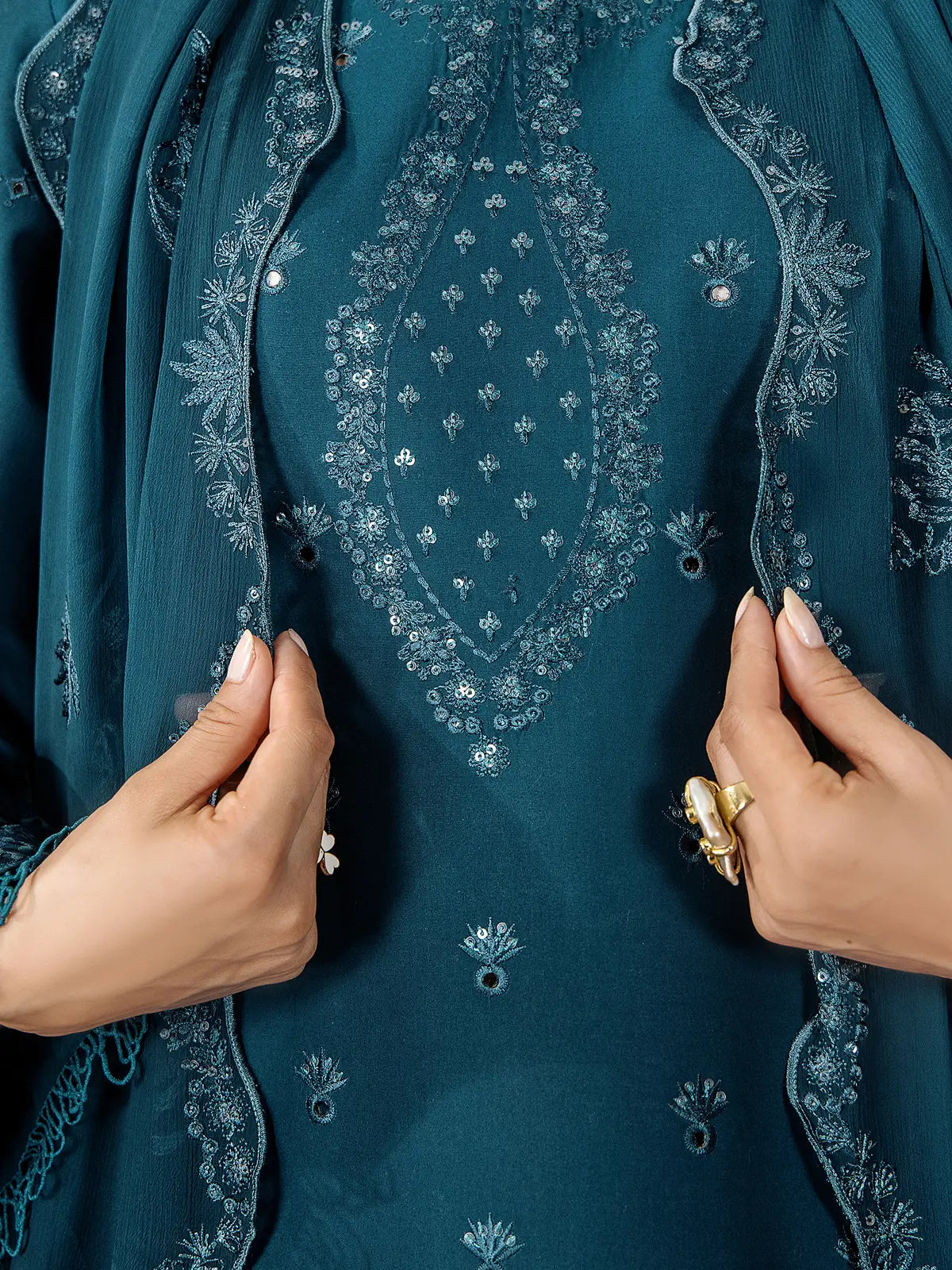 Close-up detail of hand-crafted tonal embroidery and fine sequin work on the neckline of the teal blue lawn shirt by INEJ.