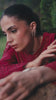 Video reel of a model twirling in an outdoor garden while wearing a deep red embroidered suit with a flowing dupatta from the Bad-e-Saba collection by INEJ.