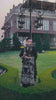 Video reel portrait of a model holding flowers while wearing a black embroidered suit with white floral thread work from the Bad-e-Saba collection by INEJ.