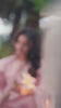 Video reel portrait of a model holding a lily flower while wearing a soft pink embroidered suit from the Bad-e-Saba collection by INEJ.